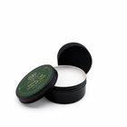 Black tin with green label on a white background