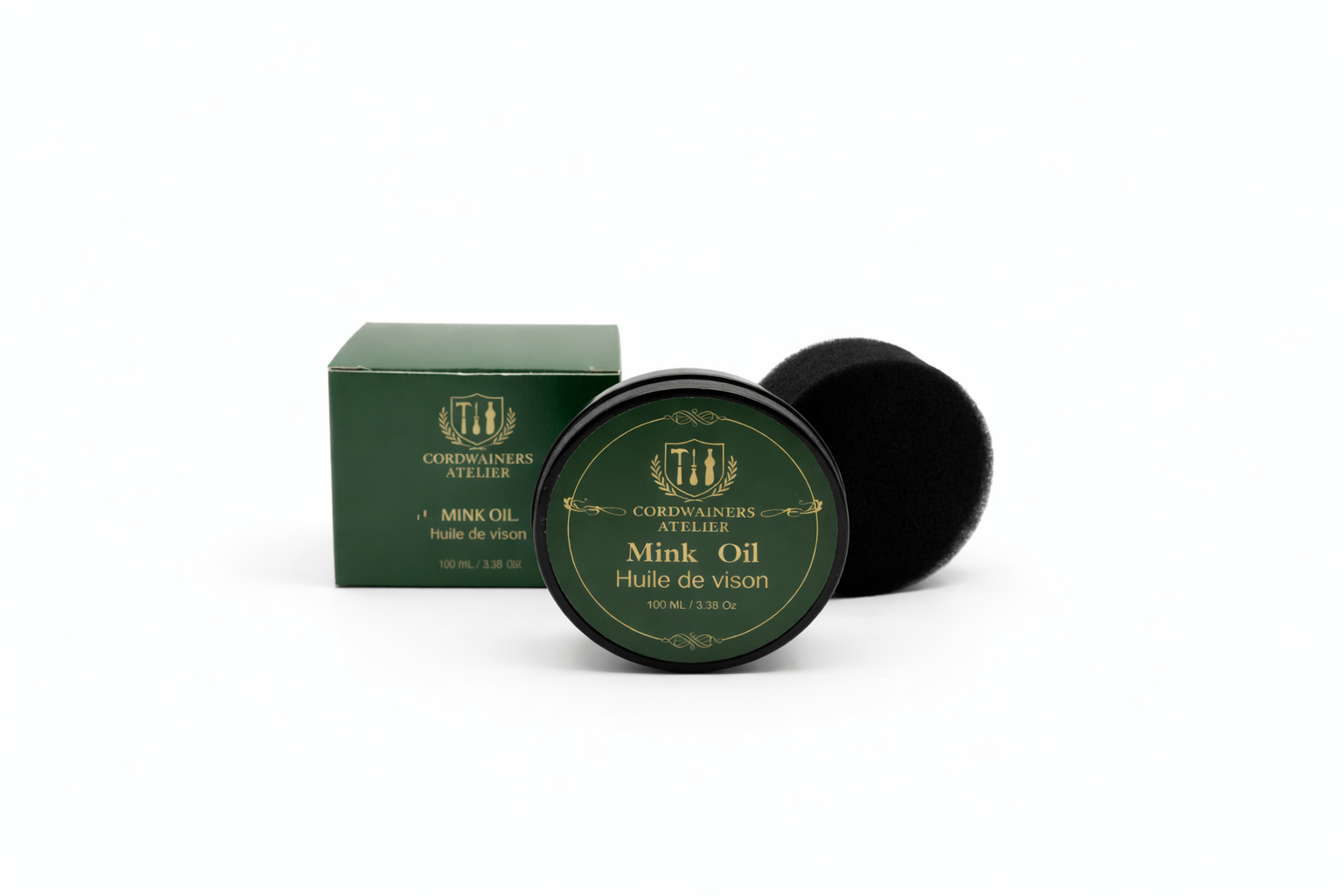 Green container of mink oil with a black lid on a white background