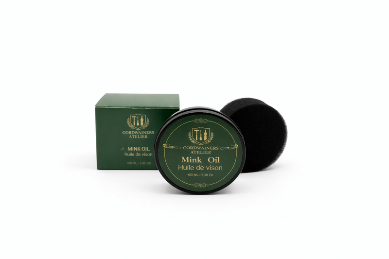 Green container of mink oil with a black lid on a white background