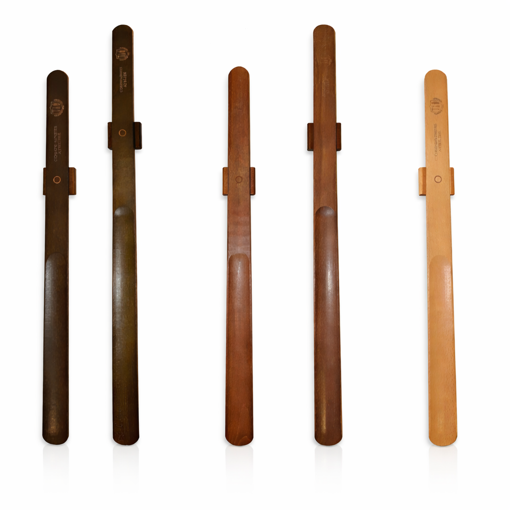 Magnetic wooden shoe horn mounted on wall for easy shoe wearing