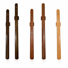 Magnetic wooden shoe horn mounted on wall for easy shoe wearing