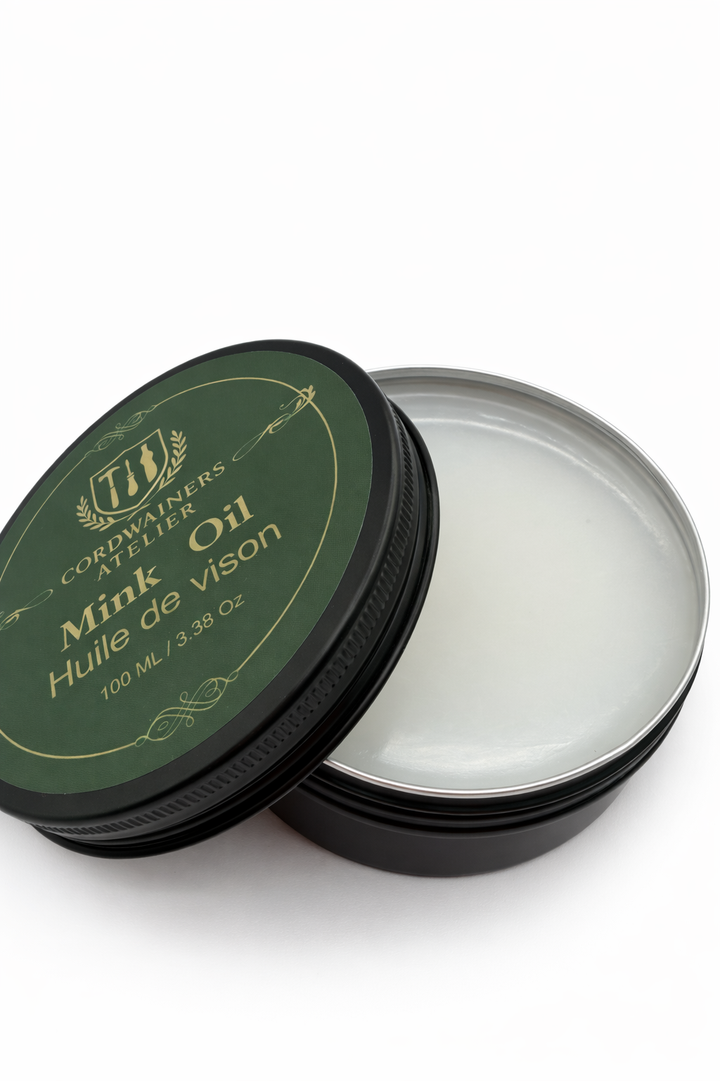 Open container of Mink Oil with green lid on a white background